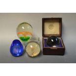 A rock crystal ball, cased; paper weights, Caithness,