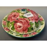 A Wemyss muffin dish, painted with roses, retailed by Thomas Goode,