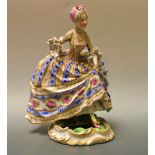 A 19th century French porcelain figure of a lady in 18th century dress and bonnet,