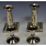 A pair of silver Neo Classical candlesticks,