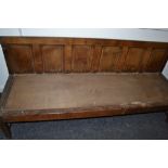A George III  oak settle, six panel back, H-stretcher,