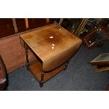 An oak drop leaf two tier trolley;