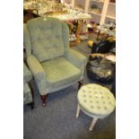 A green upholstered wingback chair ;