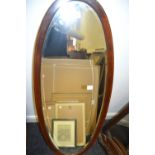 An Edwardian mahogany and satinwood strung oval mirror, 115cm high, 44cm wide, c.