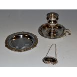 A silver chamberstick; Verona; a Victorian style circular bottle waiter ;