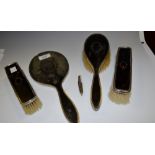 A tortoiseshell and silver 4 piece dressing table set including hand mirror;