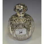 A silver mounted cut glass dressing table scent bottle, lobbed body,
