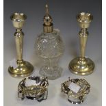 Silver - a cut glass perfume atomiser, silver top, marks rubbed; a pair of candlesticks,