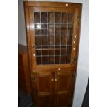 A 20th century oak corner cabinet , astralgal glazed doors, H hinges,