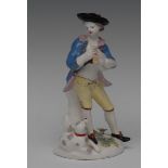 A Bow figure, of a Bagpiper, he stands wearing a broad brimmed black hat, blue jacket,