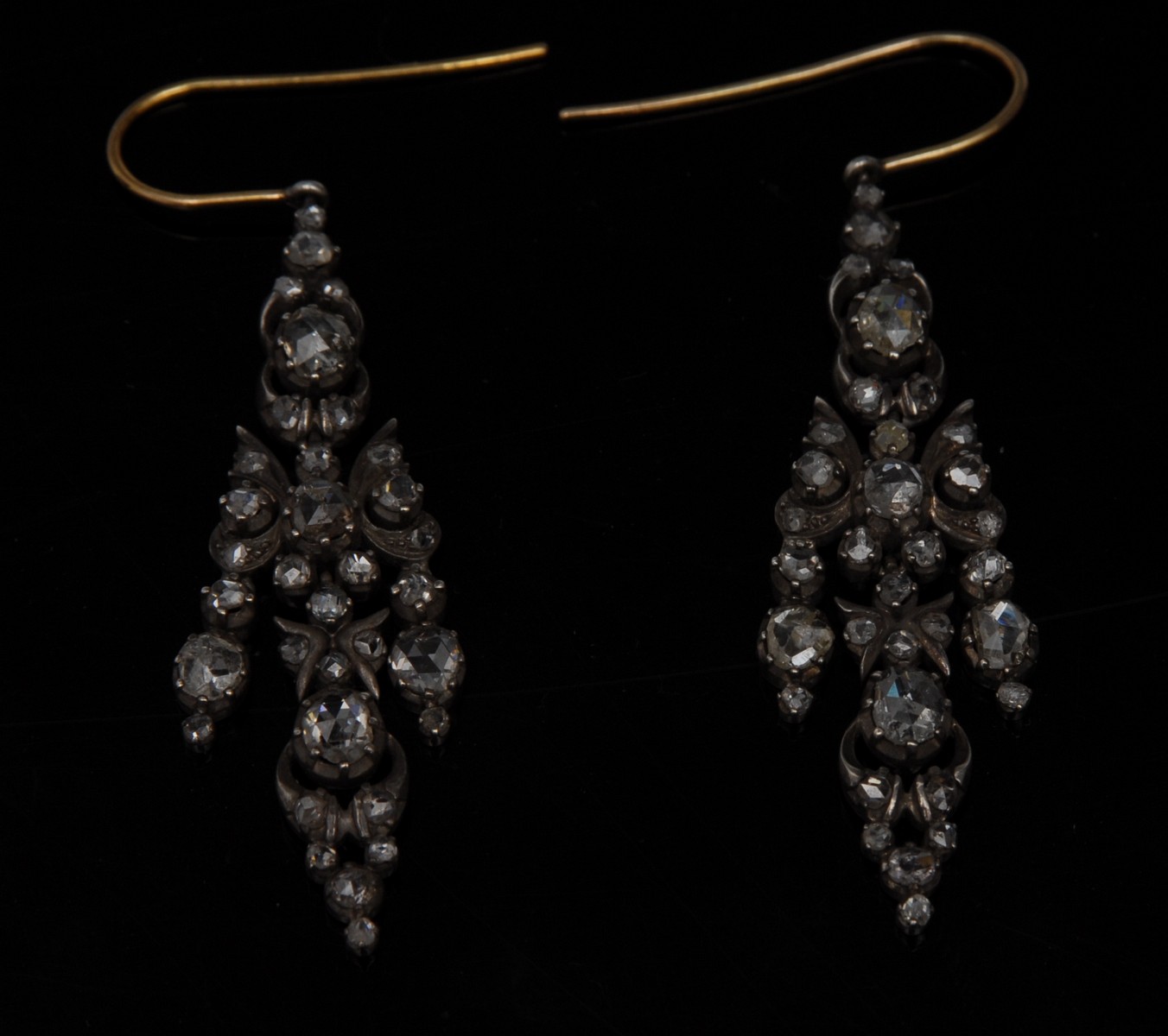 A pair of Victorian style diamond chandelier earrings, each triple section articulated body,