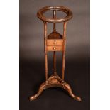 A George III mahogany wash stand, moulded circular aperture, triangular drawer, turned uprights,