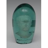 An unusual 19th century green glass dump paperweight, portrait bust inclusion,