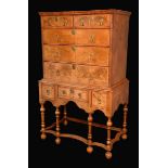 An early 18th century walnut chest on stand, feathered crossbanding,