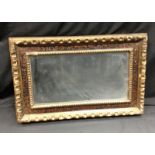 A 19th century carved, gilt and painted rectangular looking glass,
