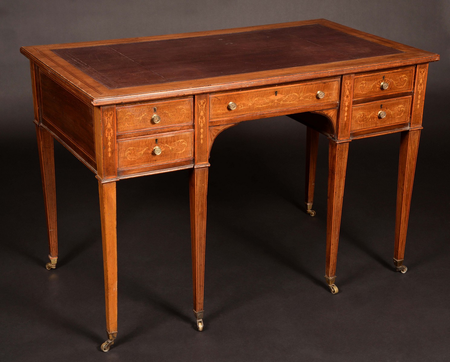 An Edwardian Sheraton Revival mahogany and marquetry desk,