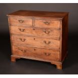 A George III mahogany bachelor's chest, of two short and three long graduating cockbeaded drawers,