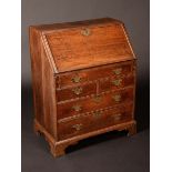 An early George III oak bureau, of small proportions,