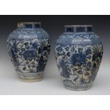 A pair of large 17th century Japanese Arita panelled hexagonal jars, decorated with stylised lotus,