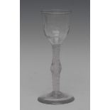 A George III opaque twist wine glass, wrythen moulded bowl, bowed stem, spreading circular foot, 16.
