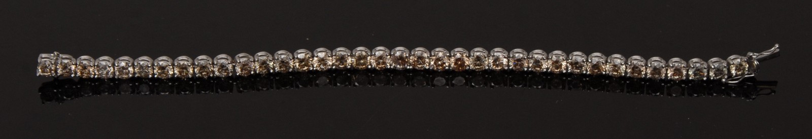 An impressive champagne diamond tennis bracelet,