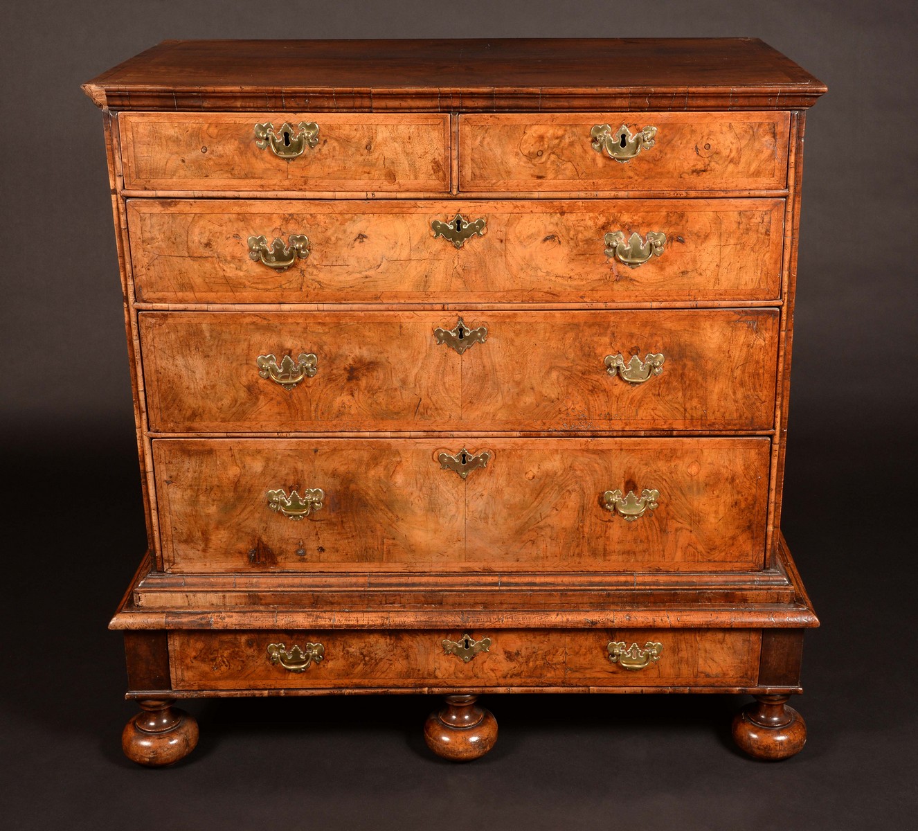 An 18th century walnut and feathered crossbanded chest, two short and three long graduated drawers,