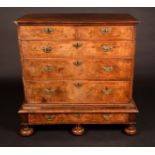 An 18th century walnut and feathered crossbanded chest, two short and three long graduated drawers,