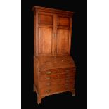A George III oak bureau cabinet,