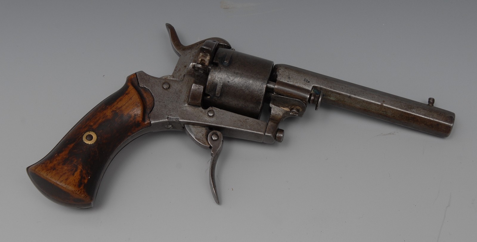 A Belgian six shot rim fire revolver, 19cm sighted barrel, folding trigger, two-piece wooden grip,