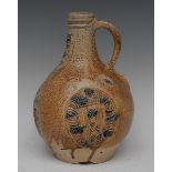 A 19th century salt glazed Belamine jug, in relief with coat of arms, the spout with mask,