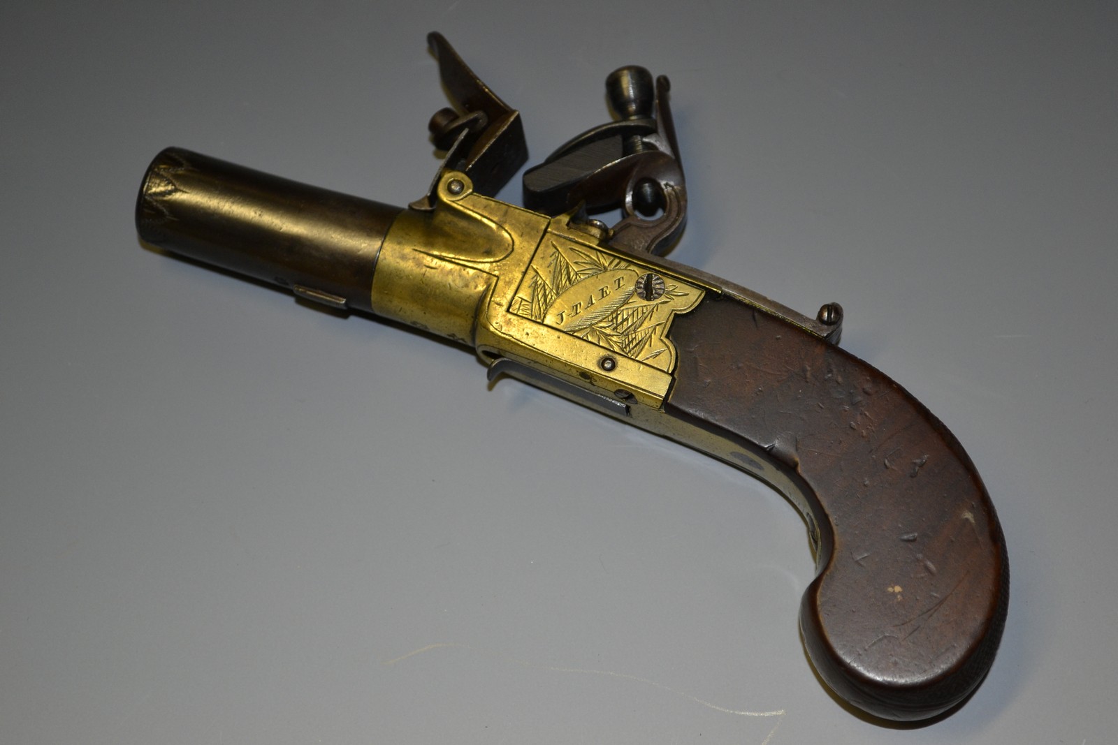 A George III flintlock pocket pistol, 4.