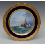 A Minton circular plate, painted in he manner of W.E.J.
