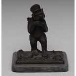 Continental School (19th century), a dark patinated bronze, of a bear street peddler, he stands,