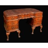 An 18th century design walnut shaped serpentine twin pedestal desk,