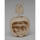 An Japanese ivory apple, carved recess with figures, hut and tree, 9cm high,