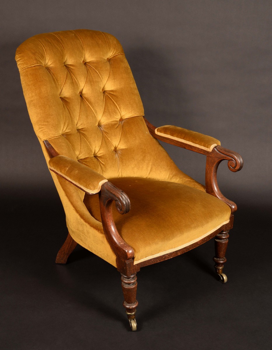 A William IV rosewood button back armchair, stuffed-over upholstery,