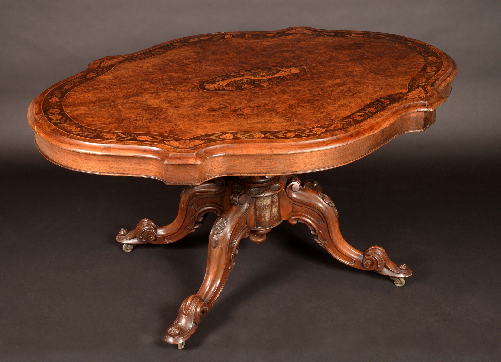 A Victorian walnut and marquetry shaped oval centre table,