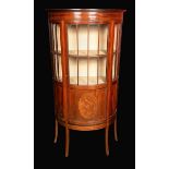 An Edwardian mahogany demi-lune display cabinet, moulded cornice above a three-quarter glazed door,