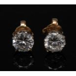 A pair of solitaire diamond stud earrings, each round brilliant cut diamond approx 0.