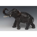 Japanese School (Meiji period), a dark patinated bronze, of an elephant, striding forward, signed,