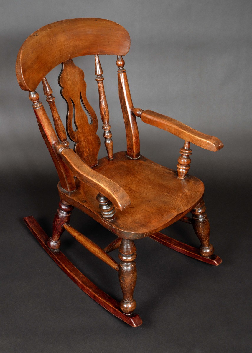 A Victorian beech child's rocking chair, arched cresting rail, pierced splat and turned spindles,