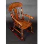 A Victorian beech child's rocking chair, arched cresting rail, pierced splat and turned spindles,