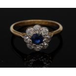 A sapphire and diamond flower cluster ring, central blue sapphire,