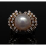 A pearl and diamond ring, central creamy pearl, 13.