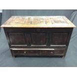 An early 18th century oak mule chest, hinged planked top with three fielded panels,