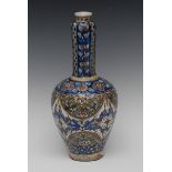 An Isnik bottle vase, typically decorated with flowers and scrolls, in tones of cobalt blue,