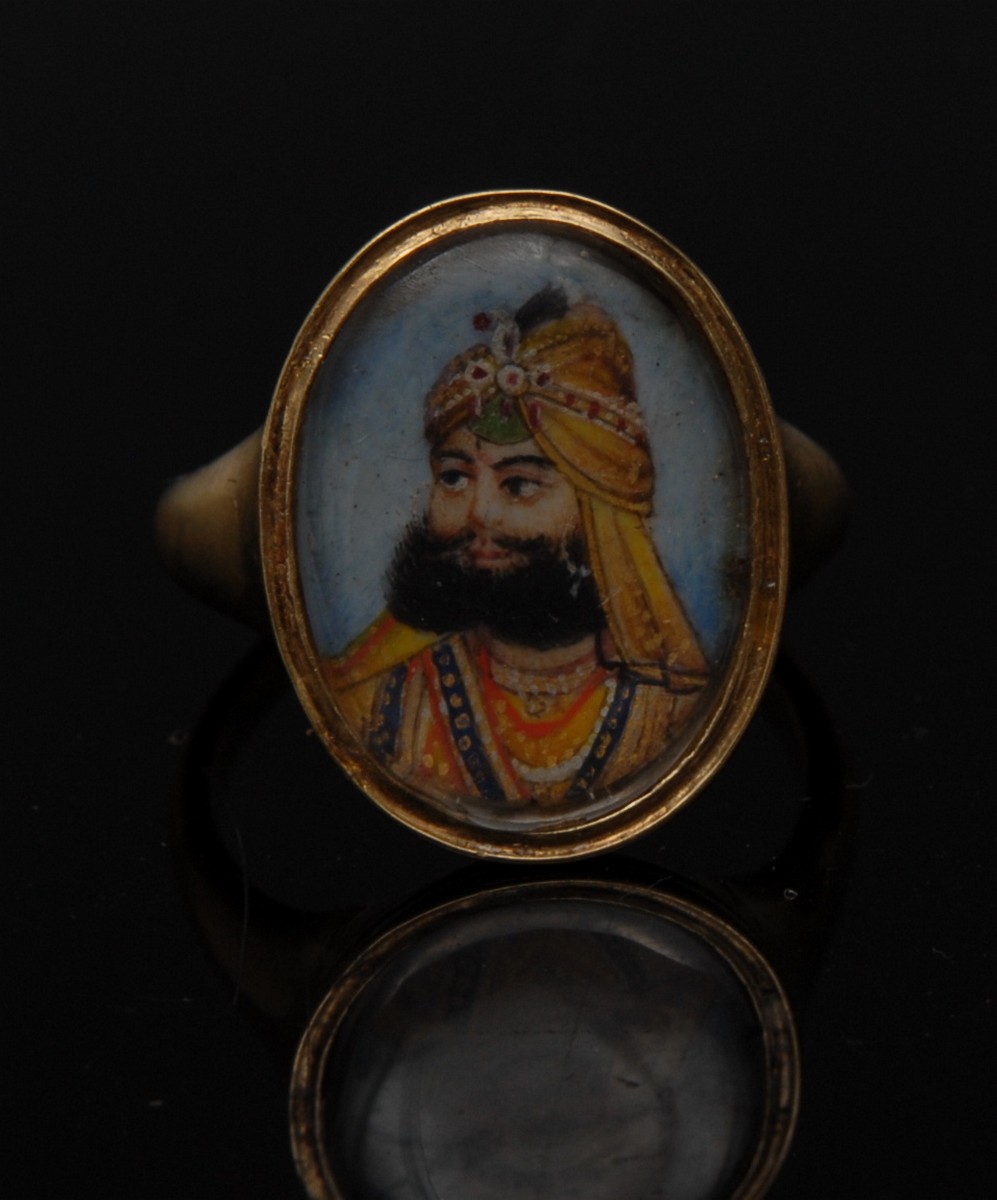 Mughal School - an Indian miniature portrait of a Maharaja on a blue enamel or glass oval plaque,