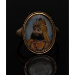 Mughal School - an Indian miniature portrait of a Maharaja on a blue enamel or glass oval plaque,