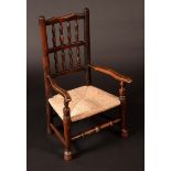 A 19th century child's ladder back elbow chair, shaped vertical splats, turned foot rail,