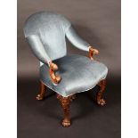 An Irish walnut library chair, arched padded back, swooping arms, scrolling terminals,